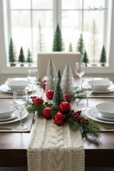 cream knitted cable braid table runner on a dining table set with place settings and bottle brush trees thumbnail