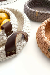 crochet baskets on a table, one with lemons in it thumbnail