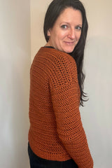 back and arm of woman wearing crochet sweater thumbnail