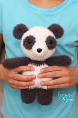 Person holding stuffed panda thumbnail