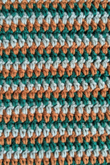 close-up of green and brown striped crochet blanket fabric thumbnail