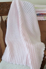 crochet baby blanket draped over chair thumbnail