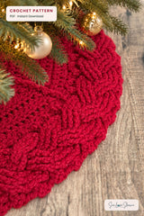 handmade red and white cable braid crochet Christmas tree skirt displayed under a tree thumbnail