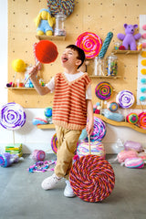 Kid holding jumbo lollipop crafts, pretending to eat one. thumbnail