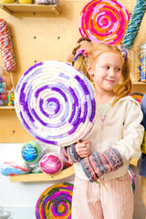 Little girl holding jumbo lollipop decoration thumbnail