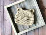 cream crocheted chunky bear beanie with ears on a wood background thumbnail