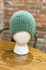 sage green knitted beanie on a white foam mannequin head thumbnail