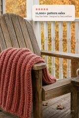 dusty pink knitted mistake rib throw blanket draped on a porch chair thumbnail