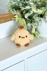 Fluffy chick stuffed animal on a shelf thumbnail