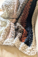 close-up of striped crochet blanket with cream border thumbnail