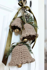 Crocheted holiday bell ornament door hanger with green ribbon and evergreen sprigs thumbnail
