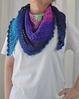 Person wearing Handmade crochet triangle shawl showing bold self-striping color changes with hand on hip and white t-shirt thumbnail