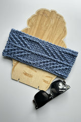 blue crocheted headband styled on a wooden display with sunglasses thumbnail