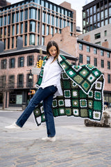 model holding granny square blanket thumbnail
