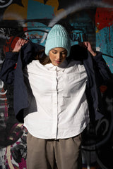 model wearing earflap hat looking down thumbnail