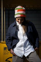 Colorful crochet hat shown on a model looking down thumbnail