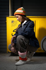 Colorful crochet hat and legwarmers on a model thumbnail