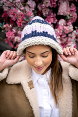 knit hat on model looking down thumbnail