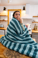 girl wrapped in striped blanket thumbnail