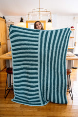 girl holding striped crochet blanket thumbnail