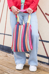 woman holding striped bag thumbnail