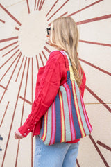 woman holding striped bag thumbnail