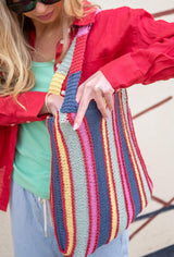 woman holding striped bag thumbnail