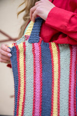 woman holding striped bag close up thumbnail
