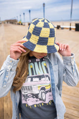woman wearing bucket hat on boardwalk thumbnail