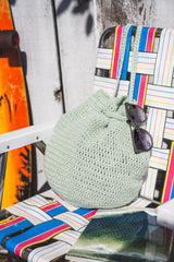 bag sitting on chair with sunglasses on it thumbnail