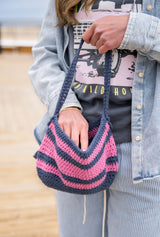 woman looking in shoulder bag thumbnail