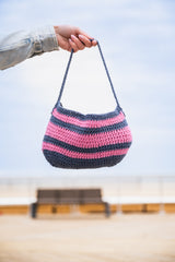 woman holding shoulder bag thumbnail