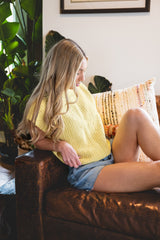 woman sitting on couch in crochet top thumbnail