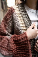 close up of Woman wearing neutral toned crochet cardigan with color changes thumbnail