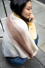 woman draped in knit blanket thumbnail