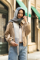 smiling woman wearing hooded scarf with one end draped over her shoulder thumbnail