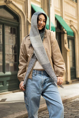 woman wearing hooded scarf with ends crossed in front of her body thumbnail