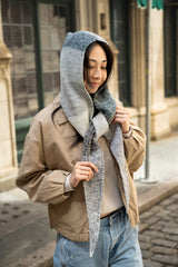 Woman wearing grayscale hooded scarf with ends tied  thumbnail