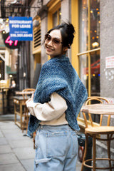 Woman looking over her shoulder wearing triangle shawl thumbnail