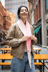Smiling woman wearing knit scarf thumbnail