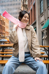 Woman wearing gradient scarf, throwing one end over her shoulder thumbnail