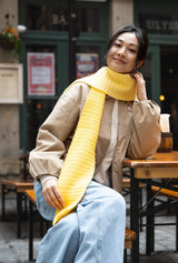 smiling woman wearing yellow gradient crochet scarf thumbnail