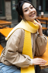 smiling woman wearing yellow gradient crochet scarf thumbnail