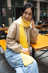 smiling woman wearing yellow gradient crochet scarf thumbnail