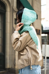 side view of woman wearing hooded scarf thumbnail