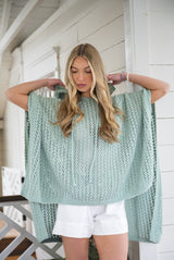 woman wearing hooded poncho thumbnail