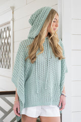 woman wearing hooded poncho thumbnail