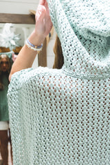 woman wearing hooded poncho thumbnail