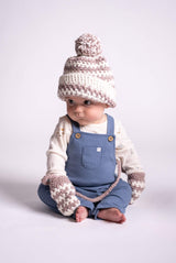 baby wearing crochet hat and mittens thumbnail