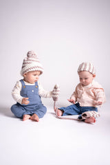 Two babies in front of a white background  wearing a striped crochet hat and striped crochet headband. thumbnail